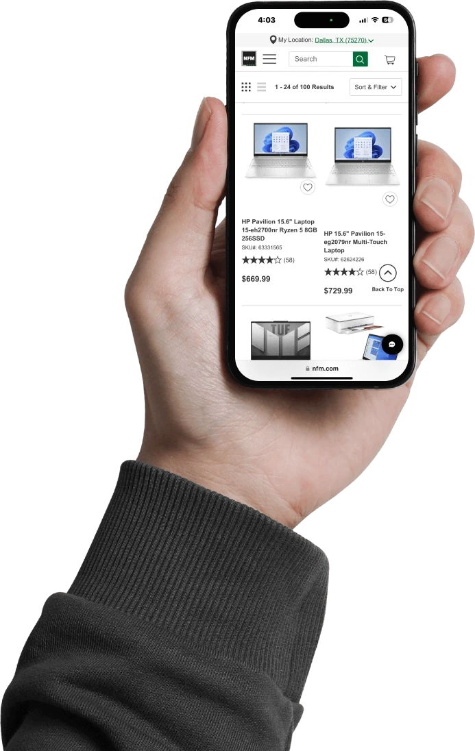 A hand holds a smartphone displaying the HP product page on Nebraska Furniture Mart’s website.