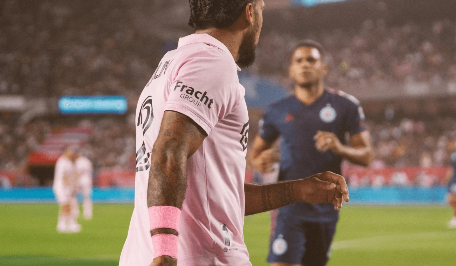 Field level view of one Inter Miami FC team member sporting the kit and showing Fracht Group logo on his arm.