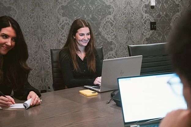 Senior Account Executive Brianne Pomierski works on her laptop during a project meeting in Adcetera’s Chicago office.
