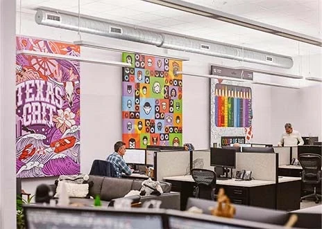 Large canvas prints mounted on the walls of Adcetera’s Midtown office in Houston, Texas, add splashes of color to the workplace.