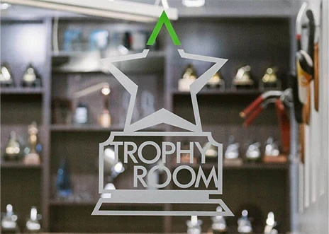 One of the conference rooms at Adcetera’s Midtown Houston office is identified by a sign stenciled on a glass door: “Trophy Room.”