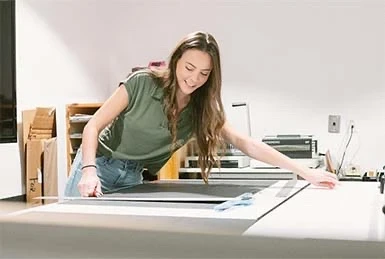 Account Executive Ariana Purcell measures a printed proof of concept at Adcetera’s Midtown office in Houston, Texas.
