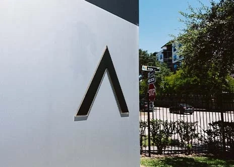 A close-up view of the Adcetera logo on the sign outside the Midtown office in Houston, Texas.