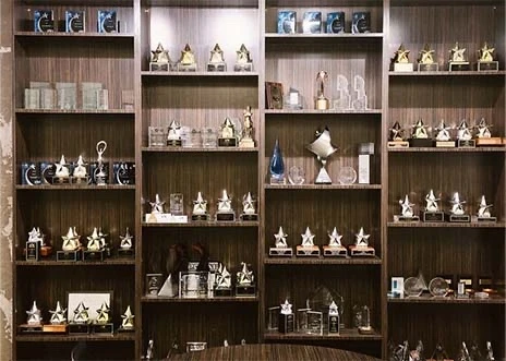 Wooden shelves display various awards and trophies in a conference room at Adcetera’s Midtown office in Houston, Texas.