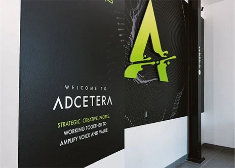 A sign printed on the wall in the lobby of the company’s Midtown office in Houston, Texas, reads “Welcome to Adcetera” and “strategic creative people working together to amplify voice and value.” 