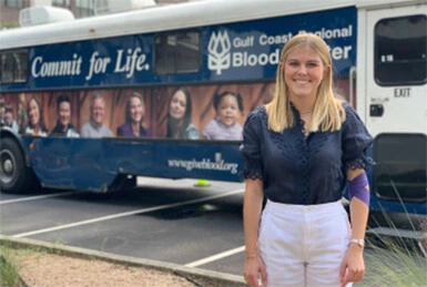 Media Operations Manager Corrine Saha stands outside the Gulf Coast Regional Blood Center donor coach in the parking lot of Adcetera’s Midtown Houston office. 